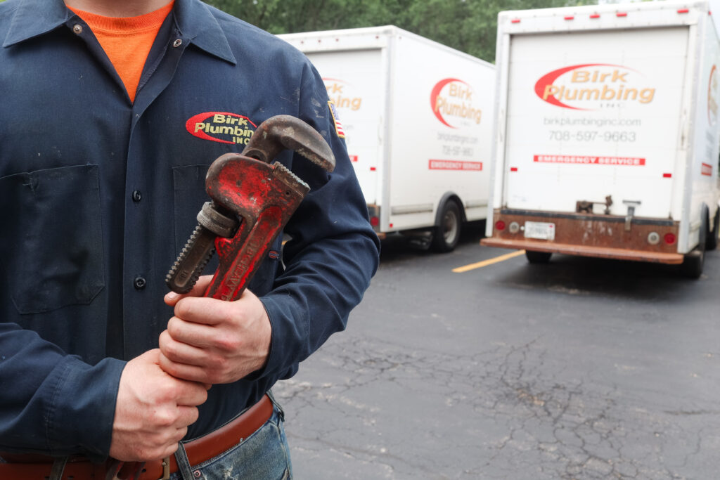 Birk Plumbing employee holding a wrench